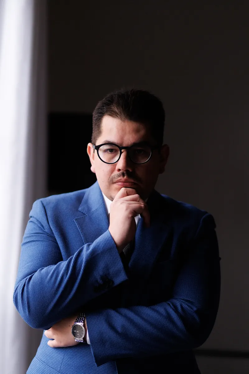 Dr. John Terrazas pensativo, com a mão no queixo